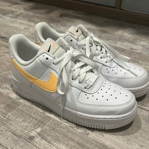 Nike White Low-Top Sneakers with Yellow Swoosh